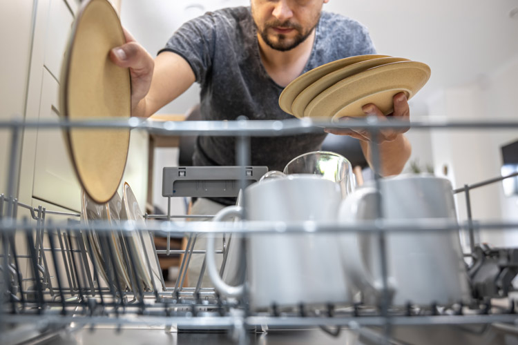 Man loading dishwasher