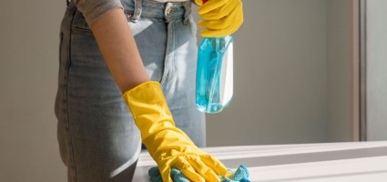 BlogImages/Person-wearing-yellow-gloves-cleaning-table.jpg