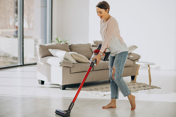 Woman vacuuming floor