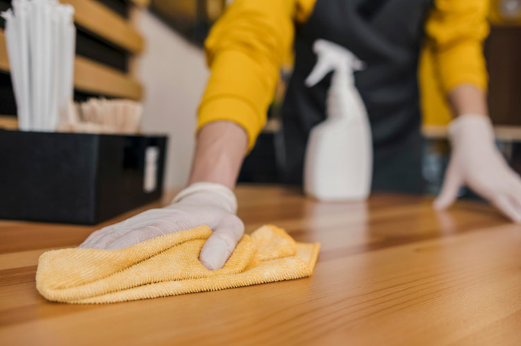 A professional cleaning wiping down hardwood floor