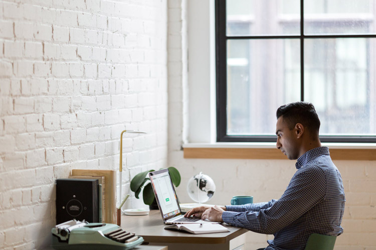 A man working at a desk at home.
