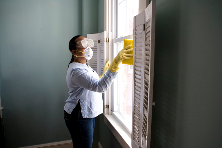 Professional cleaner scrubbing a window.