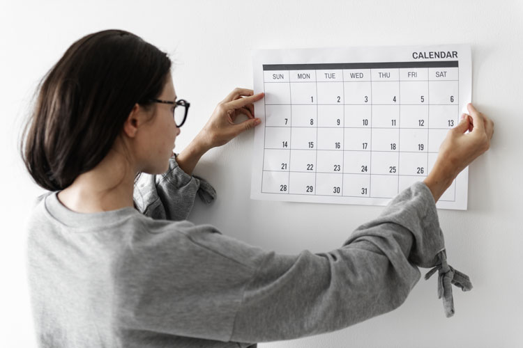 Woman creating a cleaning schedule